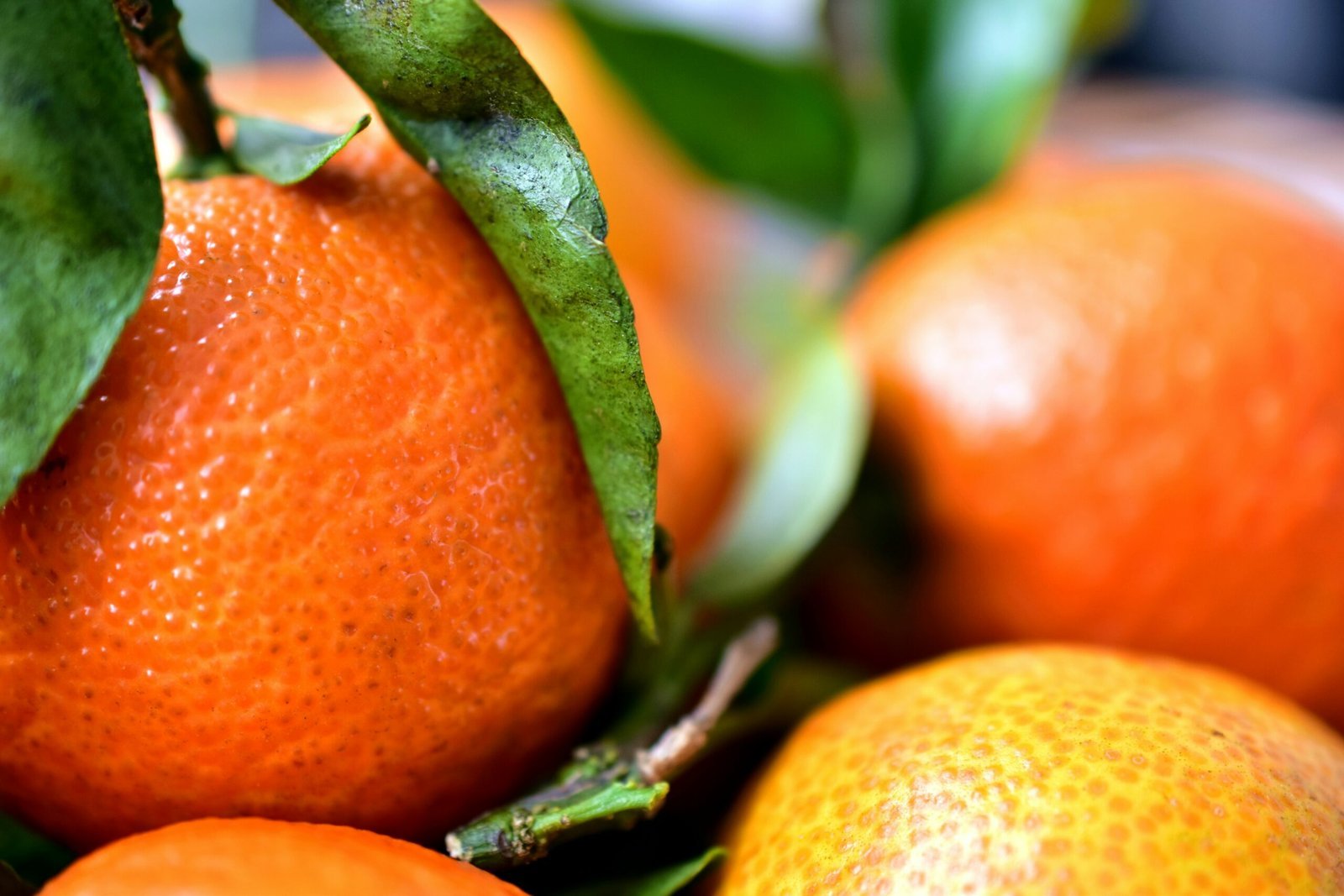 a pile of oranges sitting on top of a table